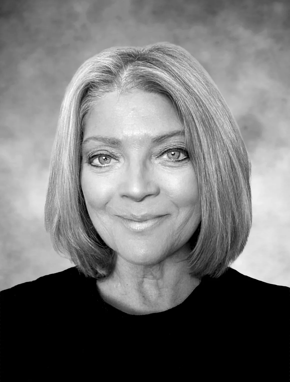 A black and white photo of a woman with short hair.