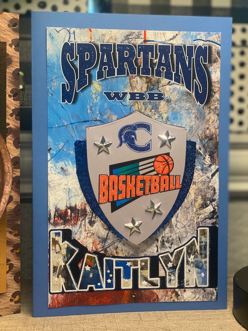 A sign that says spartans basketball and kaitlyn.