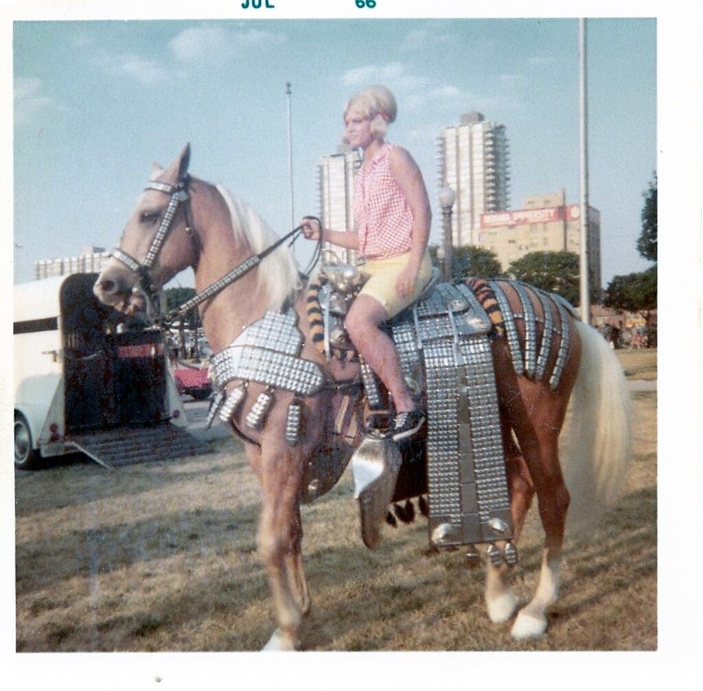 Woman riding a horse in armor.